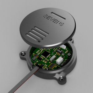 Open SEVEN9 electronics enclosure with lid removed, showing the embedded PCB and ribbon cable inside